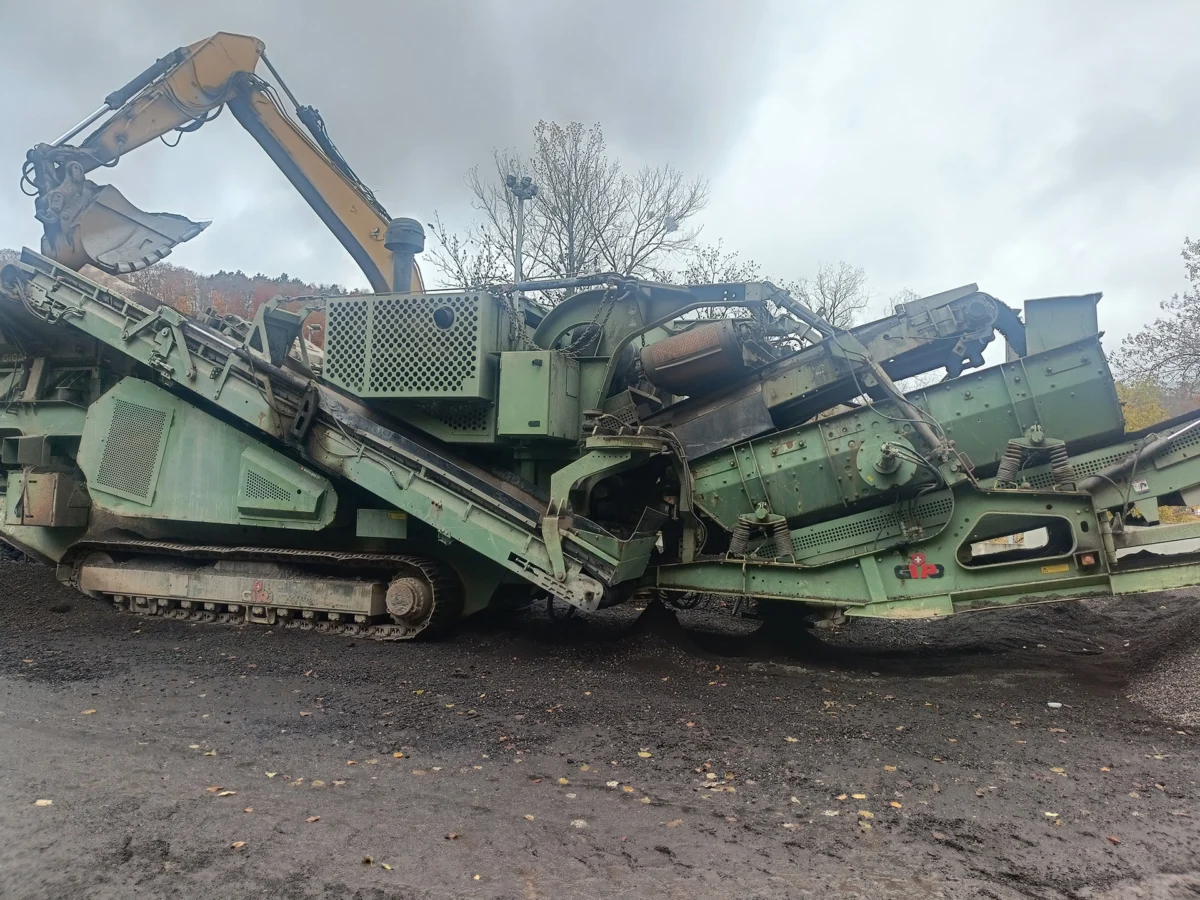 Close-up of the mobile crushing and screening plant fed by excavator
